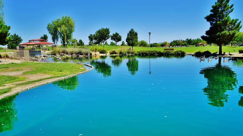 Man-made lake with a gazebo, trees and grass in a North Las Vegas park