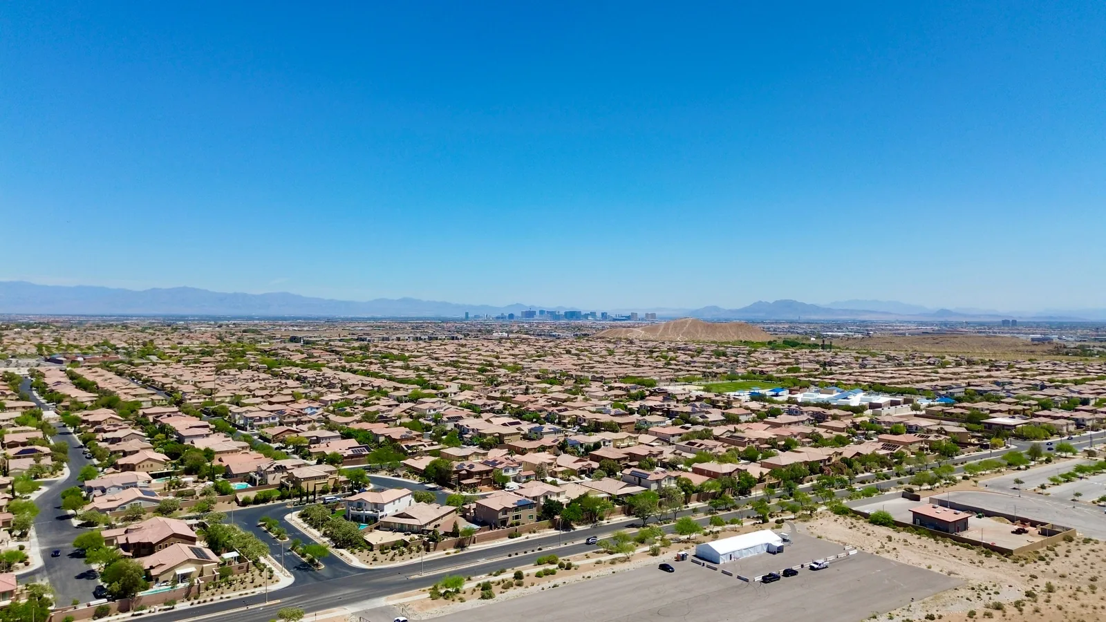 Aerial view of a residential neighborhood in the Las Vegas valley with mountains in the distance