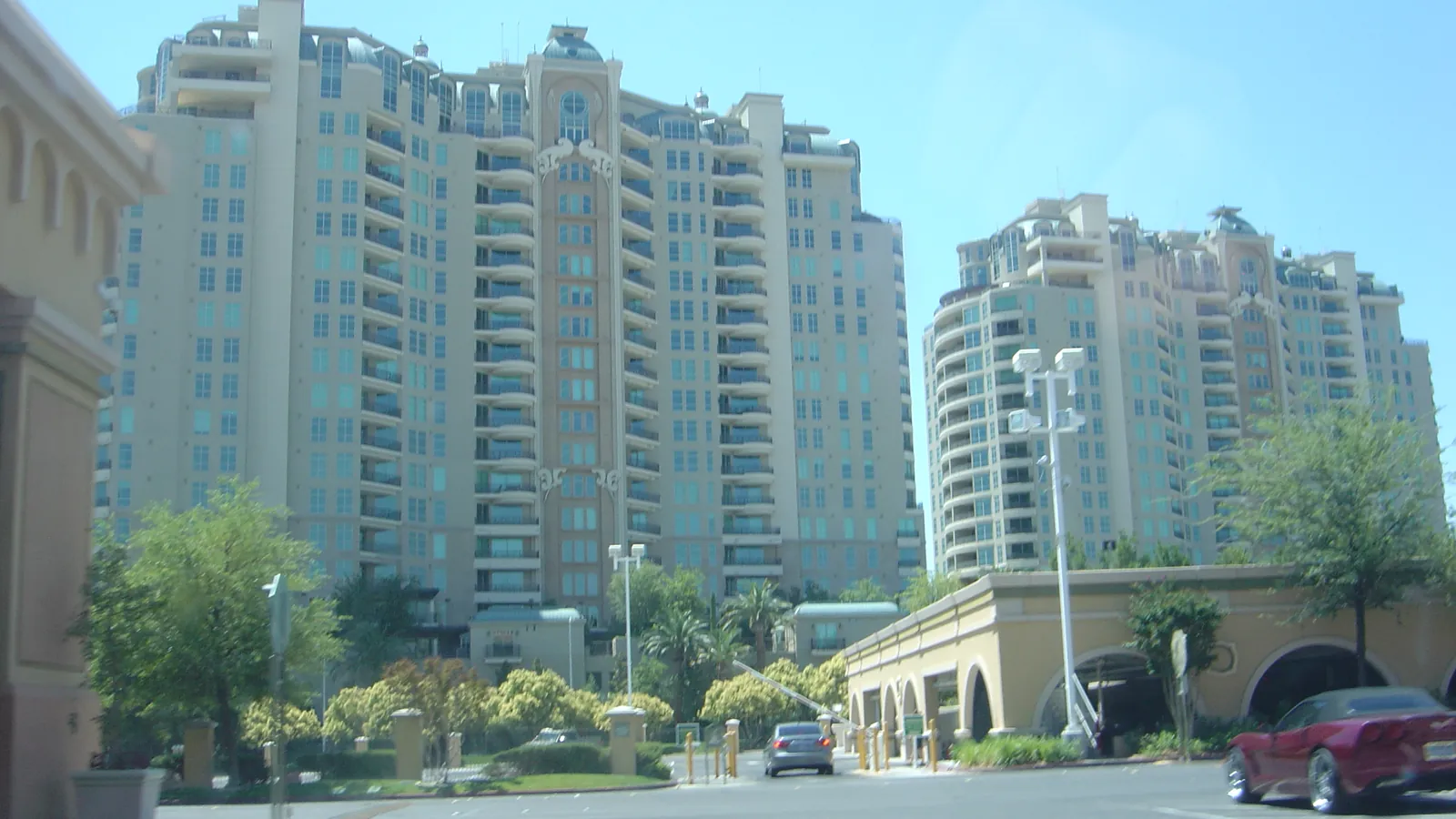 Two tall residential towers with a landscaped entrance in Las Vegas