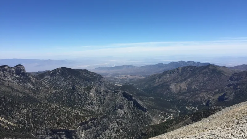 View east toward Kyle Canyon from the summit of Charleston Peak in the Spring Mountains, with the valley beyond